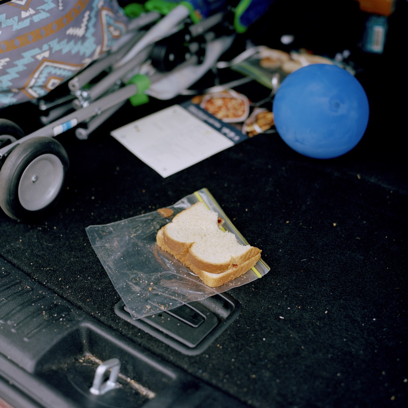 Detail of sandwich in car trunk on way to midwife checkup